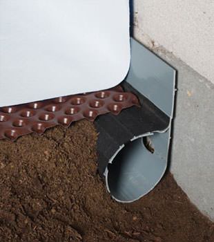 Closeup of a crawl space drainage system installed in Mocksville