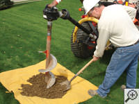 Auguring a hole in the earth for a foundation repair in Wake Forest