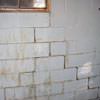 A cracked foundation wall near a window in a Graham home