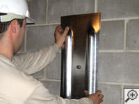 Mounting a foundation wall plate for an earth anchor installation in Asheboro.
