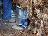 Securing a foundation footing bracket for a foundation repair system in Apex.