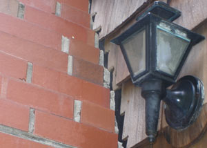 A tilting chimney in Morrisville showing serious foundation damage.