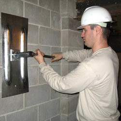 installing a wall anchor to repair an bowing foundation wall in Kernersville