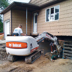Excavating to expose the foundation walls and footings for a replacement job in Cary