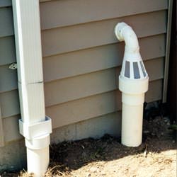 A grated sump pump discharge line fitting in Summerfield